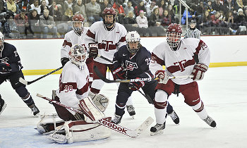Taft G Joseph Lissak fending off U.S. Women's Olympic Team F Alex Carpenter. Nov. 22 at Taft. The women won, 2-1, in OT.