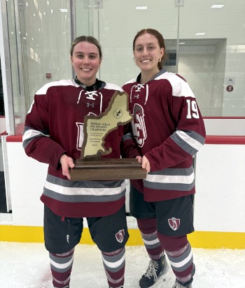 Loomis senior captains Chloe Obser (left) and Catie Collins (right) hoist the hardware.