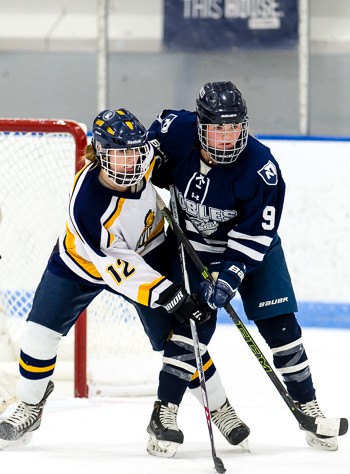 BB&N's Kayla Dunn (12) and Nobles' Abby Volo (9) battle for net-front position in Nobles' 4-0 win at the Harrington Tournament Saturday morning.